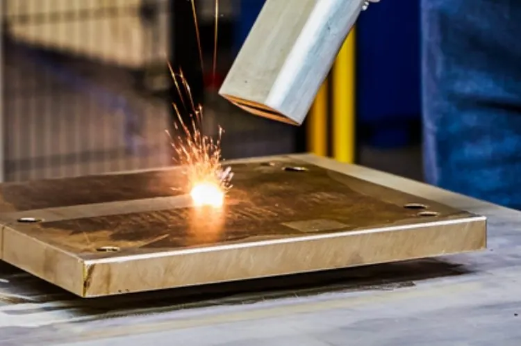 Precision laser cleaning of a brass plate