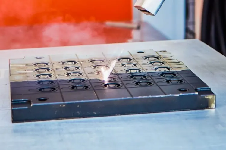 Laser cleaning an industrial metal mold