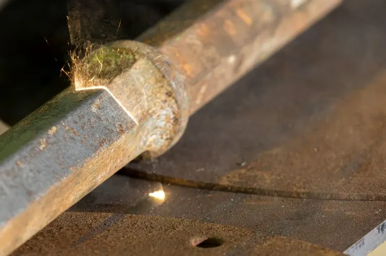 Laser rust removal on a steel pipe with sparks